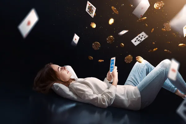 GOOD111 App — Enjoy seamless gaming on your smartphone A young woman relaxing with her phone while dynamic casino elements float around her, illustrating the smooth mobile experience offered by the GOOD111 app.