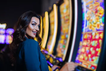 A close-up shot of golden coins falling around a spinning roulette wheel, representing immersive casino action at GOOD111.