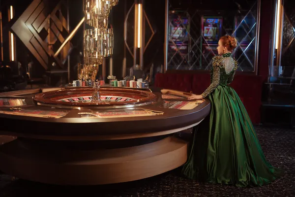 GOOD111 Games — Discover modern slots and table adventures A man celebrating a winning moment on his laptop while gaming symbols float around him, capturing the excitement of GOOD111 games.