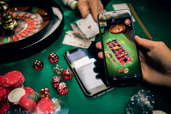 A person using their device against a moody casino-themed background, illustrating the smooth re-entry process at GOOD111.